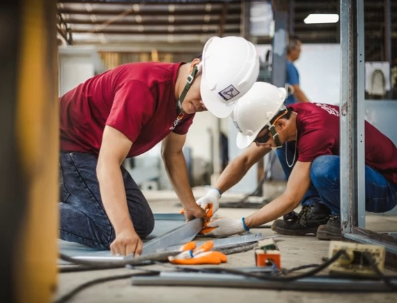 Technician assembling and wiring an electrical panel